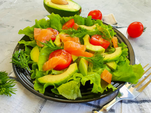 istock avocado salad, red fish on concrete background 1294306399
