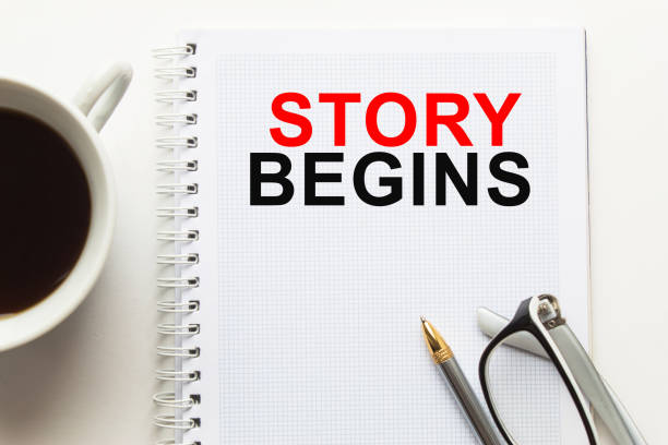 istock Notepad with inscriptions STORY BEGINS on a white background. business concept. 1294308364