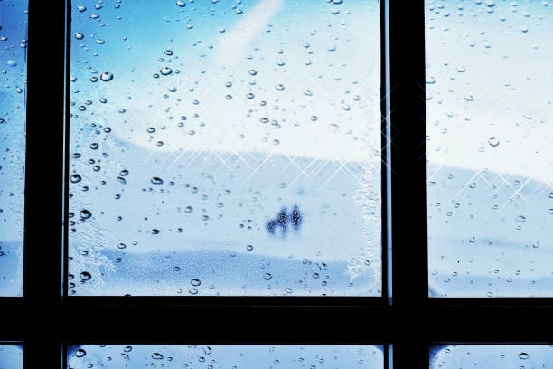 istock Looking through  a window with raindrops  and frost 1294311288