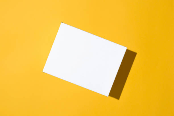 istock White box mockup on yellow background, flat lay. Blank surface of small cardboard box top view, copy space. 1294312376