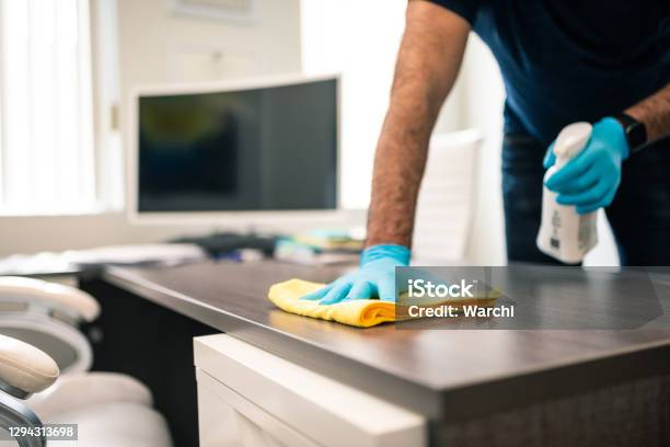 Man Disinfecting An Office Desk Stock Photo - Download Image Now - Cleaning, Office, Clean