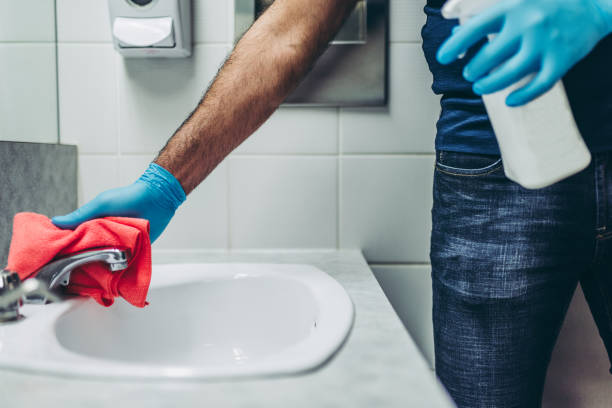 istock Hands of a janitor cleaning the bathroom 1294313922