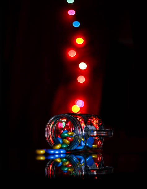 istock Colorful light bokeh and coffee mug on dark background 1294316838