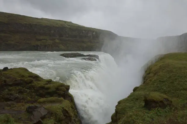 Photo of People visiting and experiencing the power of popular tourist destination - Gullfoss waterfall on Hvita river in Iceland