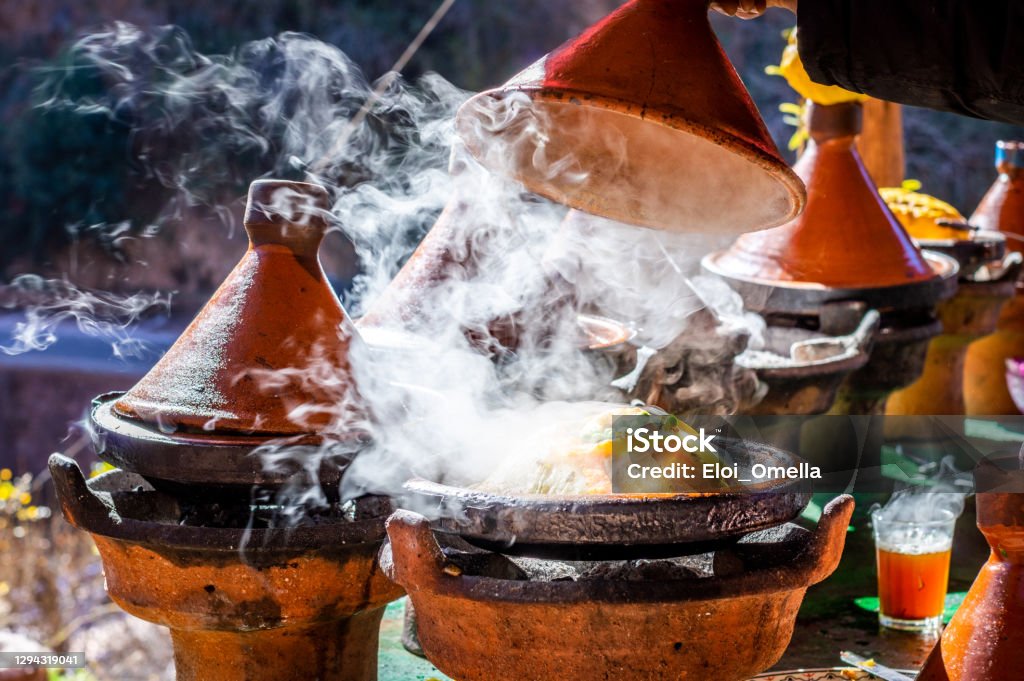 Traditional Moroccan chicken tajine with chickpeas and vegetables in a hot plate Morocco Stock Photo
