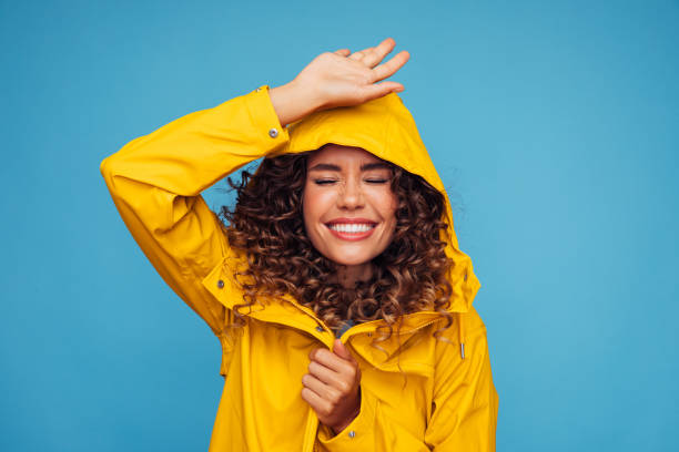 istock Smiling beautiful woman in raincoat 1294319849