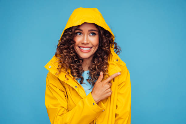 istock Beautiful woman smiling and pointing away 1294320011