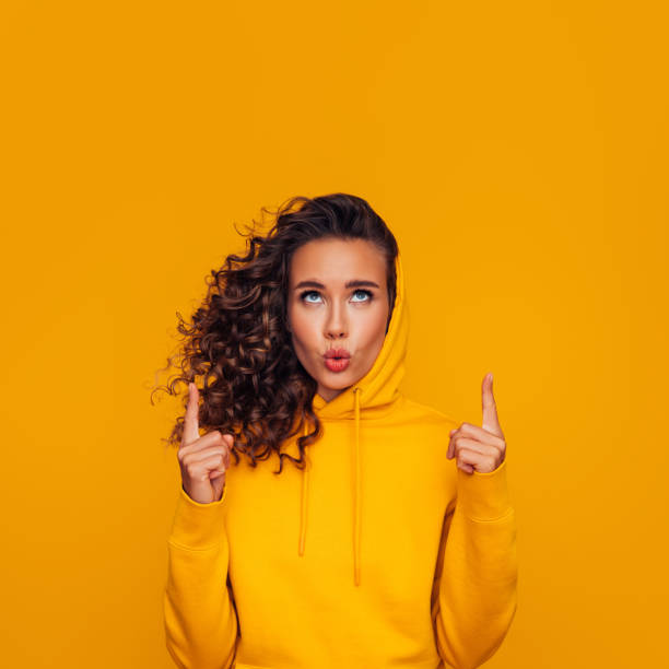 istock Beautiful surprised woman pointing up 1294321071