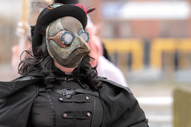Steampunk Plague Doctor Saint John, NB, Canada - October 24, 2020: A female plague doctor. She is wearing a black plague doctor costume that has a steampunk look. black plague doctor stock pictures, royalty-free photos & images