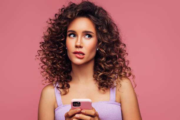 istock Woman In Wireless Earbuds Holding Smartphone 1294323431