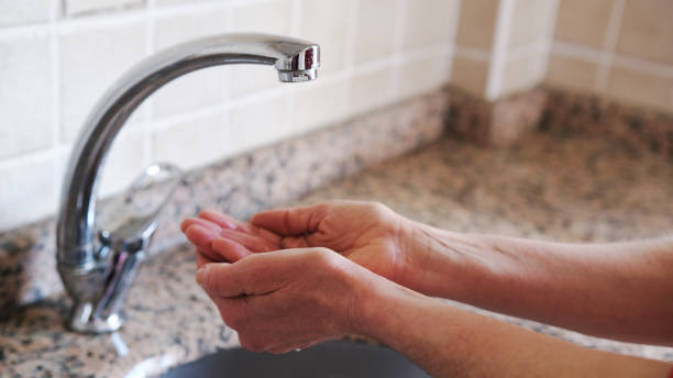 woman with open palms in front of the fountain. Middle aged woman hands and water shortage.Climate crisis.Affected of global warming made climate change. Drought concept. desert wash stock pictures, royalty-free photos & images