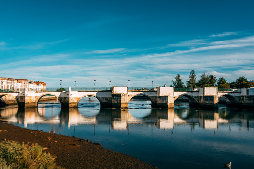 View to town and river bridge in Tavira, Portugal