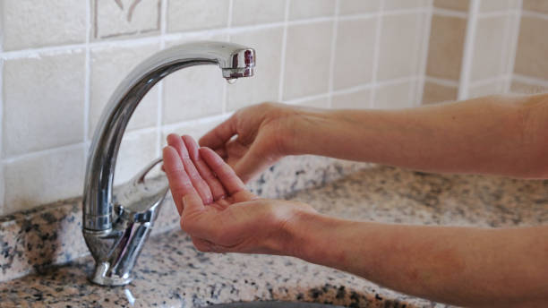 istock woman's hands opening the fountain. 1294324642