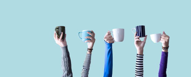 hands holding many colorful cups of coffee