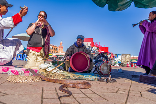 Marrakech, Morocco - January 22, 2018: Snake charmer in Djemaa El Fna Square, Marrakesh