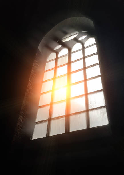istock Sunlight through the glass of an antique gothic window 1294326632