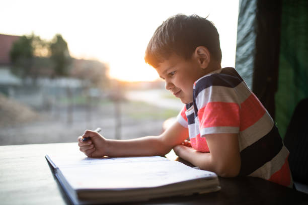istock A boy writing on the porch 1294327920