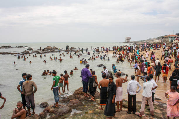 Kanyakumari, India - January 16, 2011: Group of people bathing at the local beach
