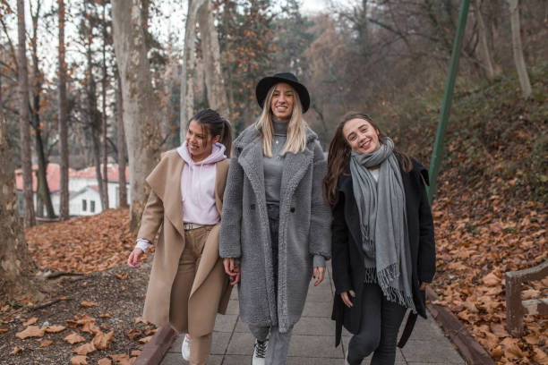 istock Three young smiling women enjoying a day in park 1294329267