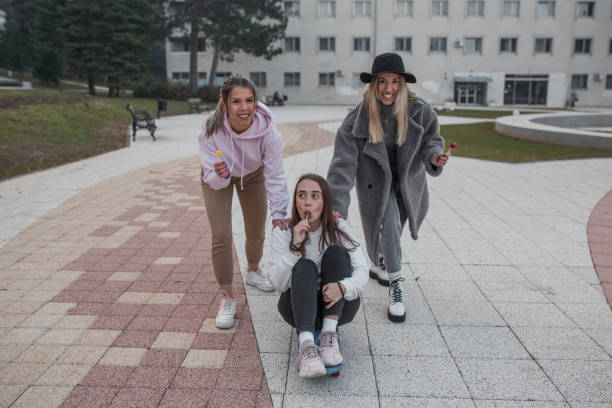 istock Three young women having fun with skateboard in park 1294329351
