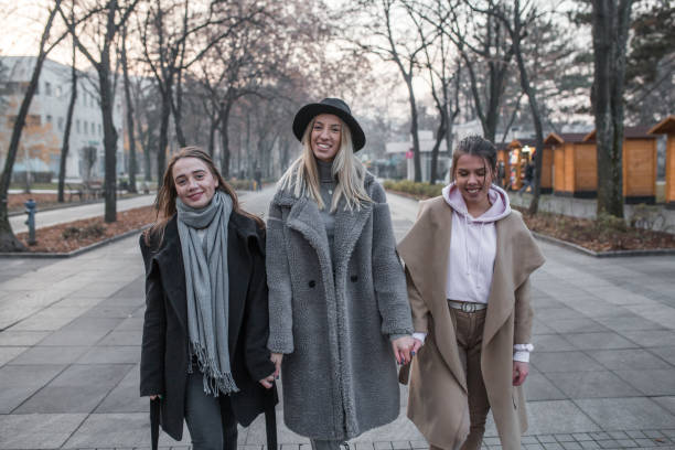 istock Three young women friends walking in park 1294329679