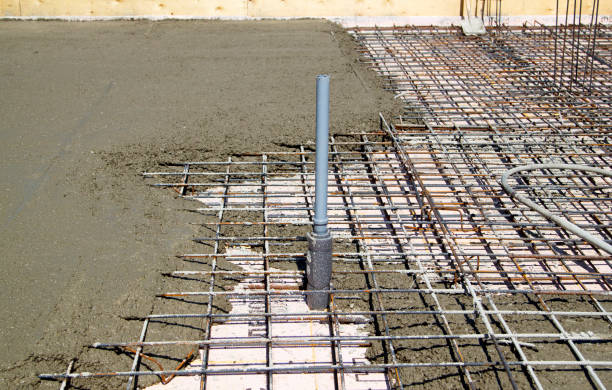 istock pouring concrete into prepared place with reinforced metal frame 1294331506