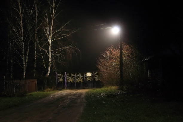 night, lantern, fog, closed gates. mysterious entrance - lock door horror gate imagens e fotografias de stock