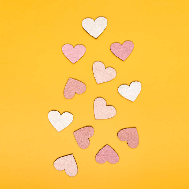 istock Creative flat lay of heart shape objects on bright yellow background. Love concept. 1294331751