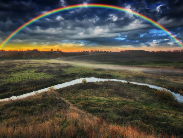 istock Amazing rainbow over the small rural river. autumn morning 1294332529
