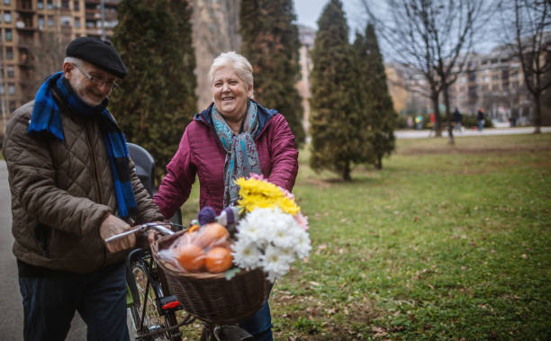 istock Active Senior Couple in Park walking with bicycle. 1294332782