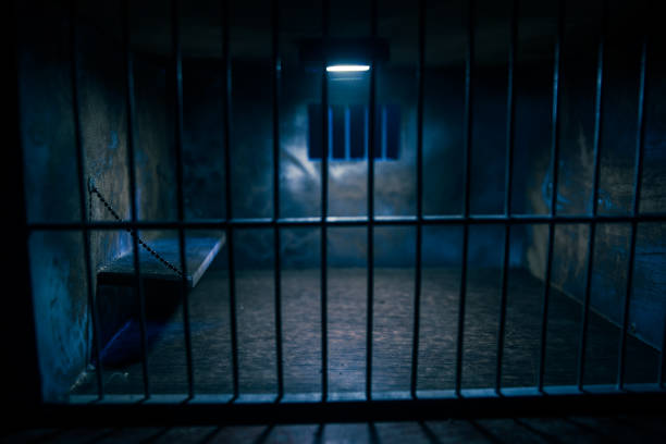 istock Jail or prison cell. Old grunge prison miniature. Dark prison interior creative decoration. Empty cell. Selective focus Obsolete gray grunge concrete room. 1294332886