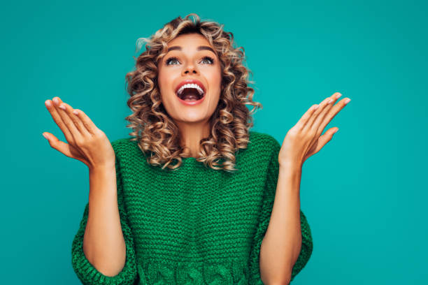 istock Beautiful girl on colored background showing up with her hands 1294334075