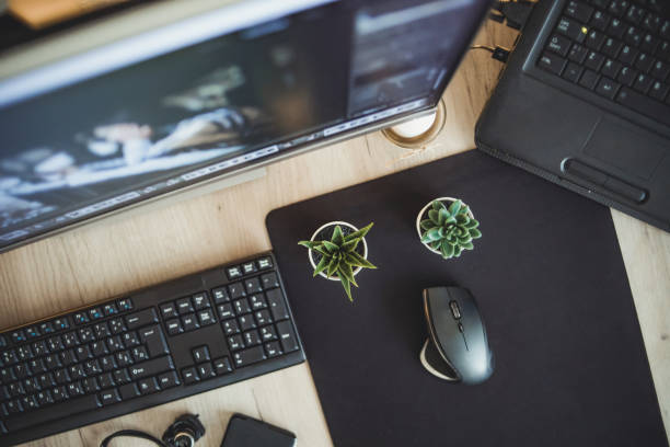 istock Top view, view of computer desk. Workspace. Wooden table top view 1294334135