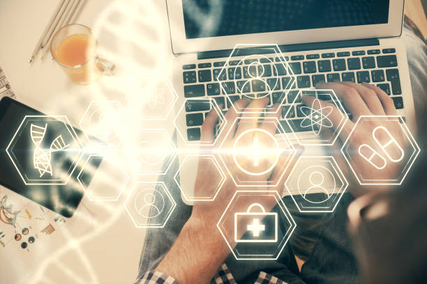 istock Double exposure of man's hands typing over computer keyboard and DNA hologram drawing. Top view. Medical education concept. 1294334201