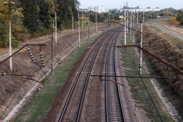 istock Electrified railway. Two railway tracks go towards the city 1294335162
