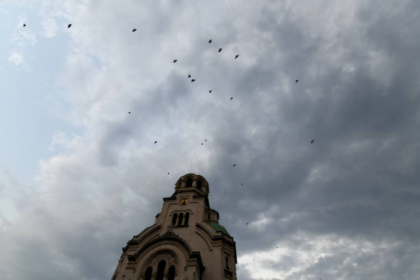 Front of Alexander Nevsky Cathedral in Sofia Bulgaria, with pigeons and gray clouds
