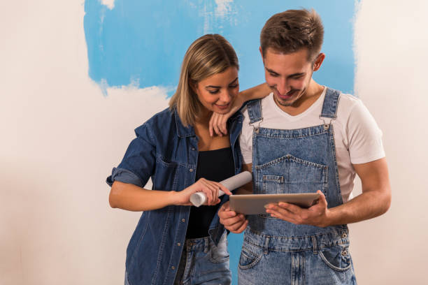 istock Couple looking at home decor ideas online on their digital tablet 1294337360