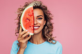 Studio portrait of a beautiful girl with watermelon