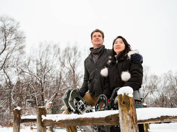 istock Mixed race couple snowshoeing in winter 1294337397
