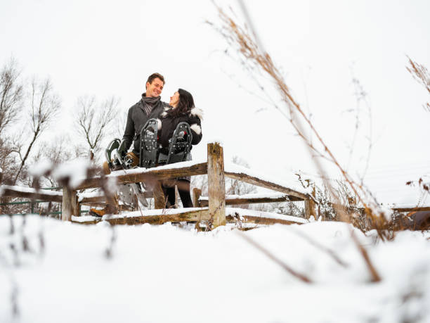 istock Mixed race couple snowshoeing in winter 1294337416