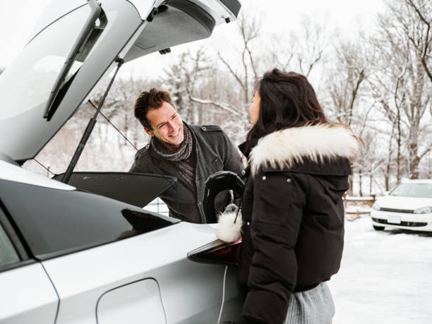 istock Mixed race couple unloading car in winter 1294337429