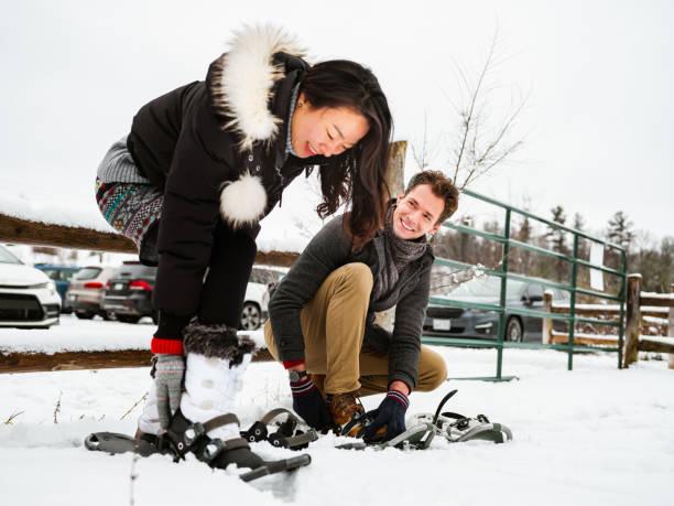 istock Mixed race couple snowshoeing in winter 1294337448