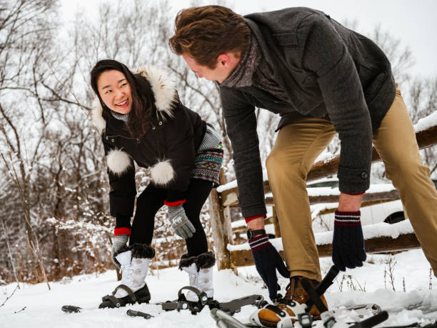 istock Mixed race couple snowshoeing in winter 1294337491