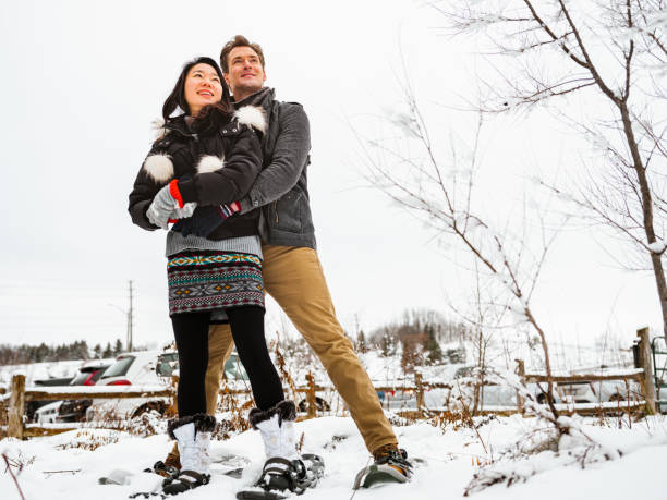 istock Mixed race couple snowshoeing in winter 1294337515
