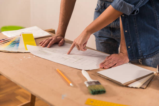 istock Pointing to what needs to be renovated first on a blueprint 1294337560