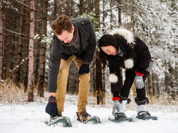 istock Mixed race couple snowshoeing in winter 1294337569