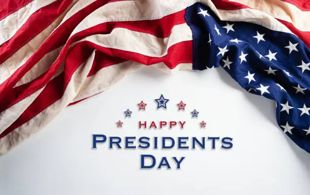 Photo of Happy presidents day concept with flag of the United States on white background.