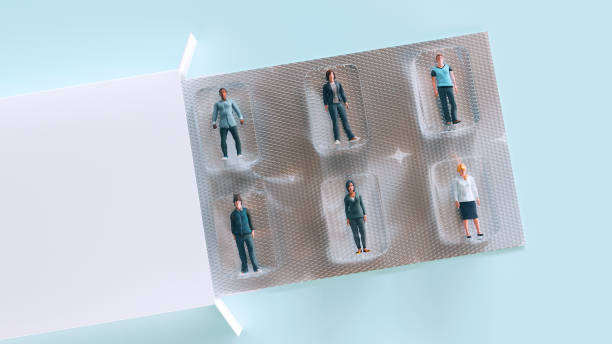 people trapped in blister pack like medicine capsules - pill box imagens e fotografias de stock