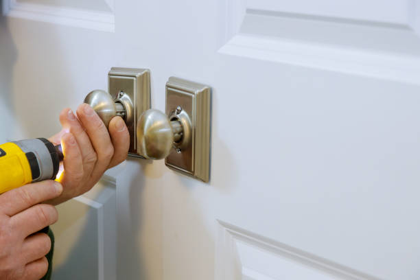 istock Master with screwdriver installs door new dummy lock in house. 1294342798