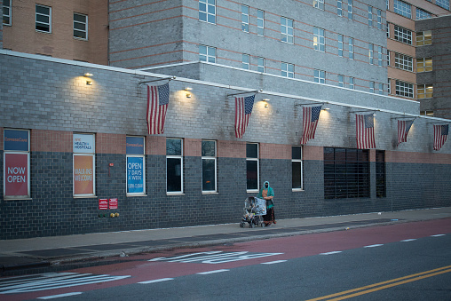 Queens, New York. January 02, 2021. A woman with a stroller outside Elmhurst Hospital Center in Elmhurst.
